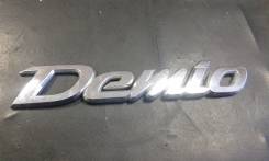 Эмблема. Mazda Demio
