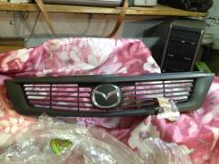 Эмблема решетки. Mazda Familia